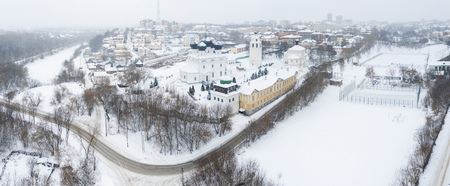 the city of Kirov and the high bank of the river Vyatka and the Alexander Grin Embankment and and Trifonov Monastery on a cloudy winter day.の写真素材