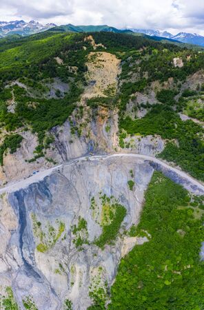 Amazing view of the landslide on a mountain road. The road from Mestia to Zugdidi was blocked by an rockfall. Road services are clearing the mountain road serpentine.の写真素材