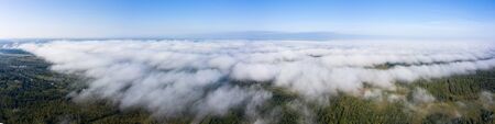 Beautiful hight way road high angle beautiful view of the fog over the road on an early summer morning in central Russia. Bird's eye view of the road and skyline.の写真素材