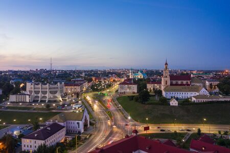 Grodno Regional Drama Theater and Holy Cross Church And Traffic In Mostowaja And Kirova Streets in the morning light. Grodno city in Belarus. Aerial view from a drone.の写真素材