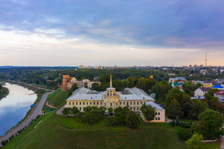 New Castle on high river bank of Neman in Grodno in sunset light, Aerial view from a drone.,...
