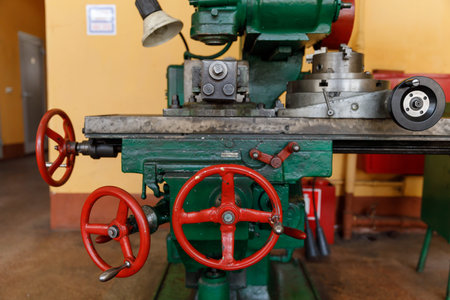 red controls of the Universal old and green Milling Machine.