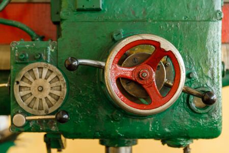 red controls of the Universal old and green drilling machine.の写真素材
