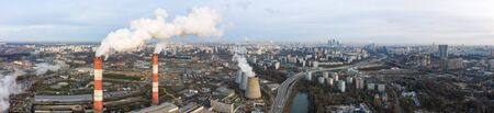 power plant pipes and cooling towers on the background of the panorama of the winter city against blue sky. Ochakovo-Matveyevskoye Districtの写真素材