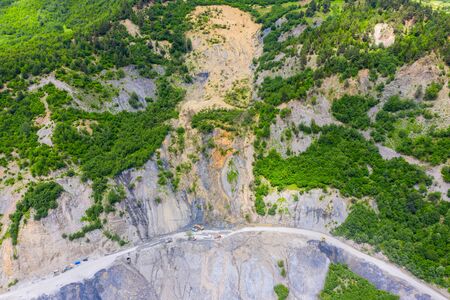 Amazing view of the landslide on a mountain road. The road from Mestia to Zugdidi was blocked by an rockfall. Road services are clearing the mountain road serpentine.の写真素材