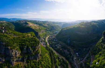 The city of Chiatura and the Mining plant and manganese ore processing plant located in the gorge of the Kvirila River, a tributary of the Rioni and on adjacent plateaus.の写真素材