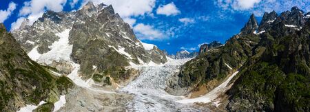 Caucasus Mountains on the border of Russia and Georgia. Chalaat Pass and Very beautiful view of the Chalaadi Glacier, Mount Ushba and Mestiachala river with background of clear blue sky.の写真素材