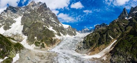 Caucasus Mountains on the border of Russia and Georgia. Chalaat Pass and Very beautiful view of the Chalaadi Glacier, Mount Ushba and Mestiachala river with background of clear blue sky.の写真素材