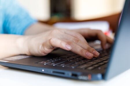 Female hand on a laptop, touchpad. remote work at the laptop. concept of Remote work or Freelance at the quarantine in the pandemic.の写真素材