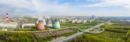 power plant pipes and cooling towers on the background of the panorama of the Moscow city against blue sky. Biryulyovo district in the south of Moscow.の写真素材