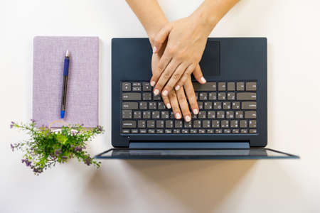 Female hand on a laptop, touchpad. remote work at the laptop. concept of Remote work or Freelance at the quarantine in the pandemic.の写真素材