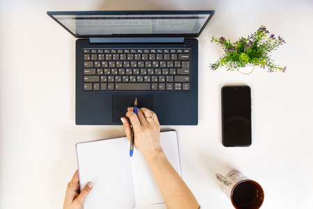 Female hand on a laptop, touchpad. remote work at the laptop. concept of Remote work or Freelance at the quarantine in the pandemic.の写真素材