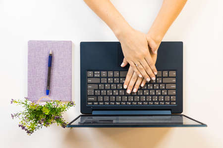 Female hand on a laptop, touchpad. remote work at the laptop. concept of Remote work or Freelance at the quarantine in the pandemic.の写真素材