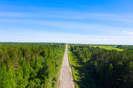 bad asphalt road with large holes top view, federal highway of the Vologda and Kostroma regions in the north of Russia.の写真素材