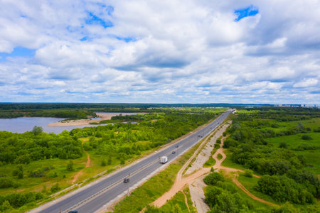 Panorama of the Kirov city and Oktyabrsky district in the nord part of the city of Kirov on a summer day from above. highway across the bridge over the Vyatka river at the entrance to the city.の写真素材