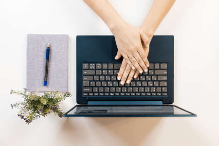 Female hand on a laptop, touchpad. remote work at the laptop. concept of Remote work or Freelance at the quarantine in the pandemic.の写真素材