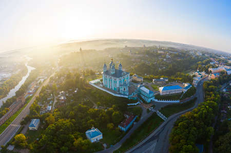 Aerial view of Uspenskiy Cathedral in Smolensk, Early summer morning and fog over the city in the rays of the rising sunの写真素材