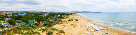 A picturesque panorama of the sea coast with a sandy beach in a resort near the city of Anapa and the village of Vityazevoの写真素材