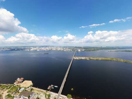 a panoramic view of the banks of the Volga River near Saratov, an automobile bridge across the river in the city limitsの写真素材