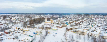 Panorama of a small city in the depths of Russia from a height. Orthodox churches and traditional old wooden houses, Kologriv and winter city viewの写真素材