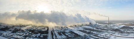Industrial landscape. Panoramic view of the technological pipe and industrial infrastructure. Chemical production with red-white pipes and smoke is coming. Production buildingsの写真素材