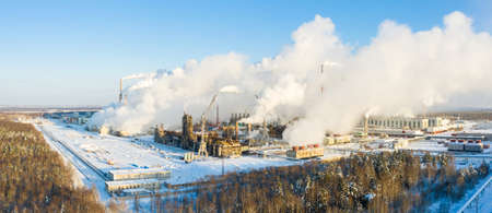 Industrial landscape. Panoramic view of the technological pipe and industrial infrastructure. Chemical production with red-white pipes and smoke is coming. Production buildingsの写真素材