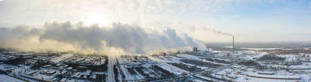 Industrial landscape. Panoramic view of the technological pipe and industrial infrastructure. Chemical production with red-white pipes and smoke is coming. Production buildingsの写真素材
