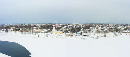 Panorama of a small city in the depths of Russia from a height. Orthodox churches and traditional old wooden houses, Totma and winter city viewの写真素材
