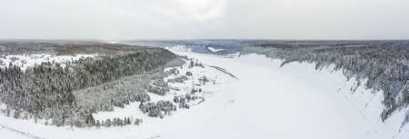 village of Porogi and the river Sukhona in winter with old river locks on the ancient trade route from the Varangians to the Greeksの写真素材