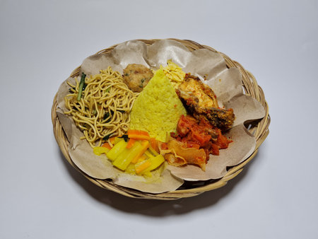 Yellow tumpeng rice with various side dishes