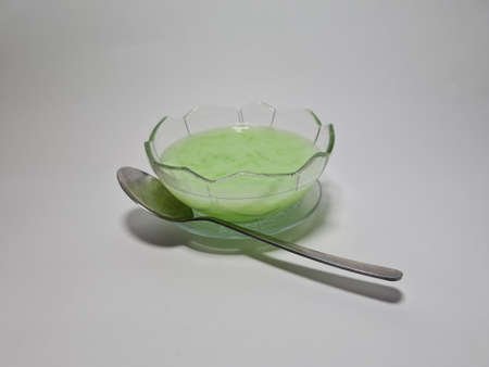 Green fresh ice in a plastic cupの写真素材