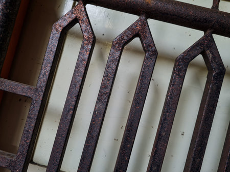 The background of the white wooden door in front of it is a brown iron fence as a security