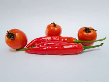 Big red chilies with green handles and big red chilies on a white background for extra cooking spicesの写真素材