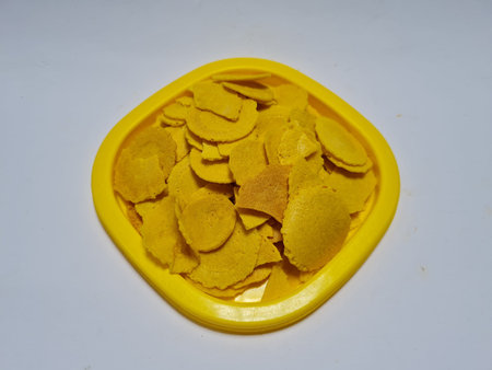 A snack called dollar made of flour, sugar and other ingredients that are brown in a yellow...