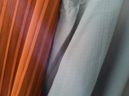 Abstract fabric textured background in orange combined with light blue