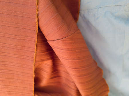 Abstract fabric textured background in orange combined with light blueの写真素材