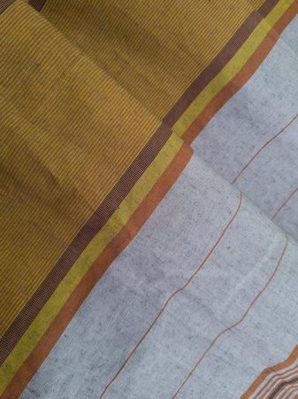 Abstract background with folded sarong textured in golden brown and white in other colors