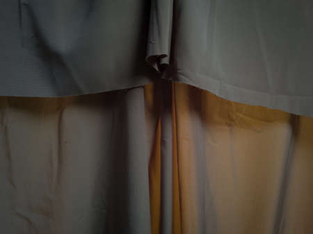 Dark brown textured textured fabric background folded folded and shadingの写真素材