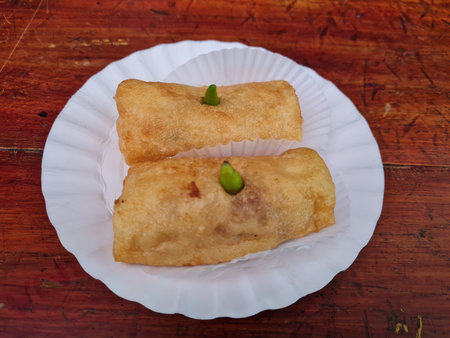 Cakes made from flour, sliced chicken and other ingredients in a white container are called risoles