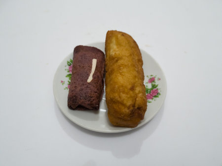 A market snack made of flour and other ingredients with fried bread and brown omelette