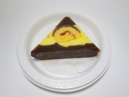 Wet cake made of jelly and biscuits in a white container