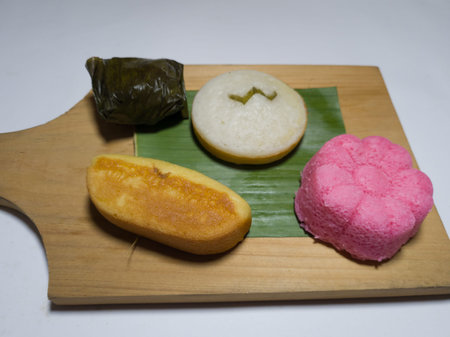 The four market cakes are white apem, red apem, pukis cake and mendut cake wrapped in banana leaves