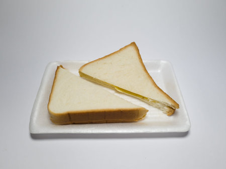 Photo of white bread with pineapple jam in a white container