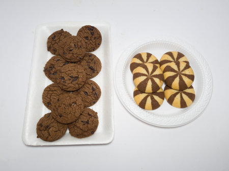 Chocolate chip cookies made of flour and other ingredients on a white background