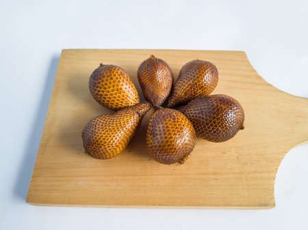 Snakefruit with dark brown skin, the fruit is under the treeの写真素材