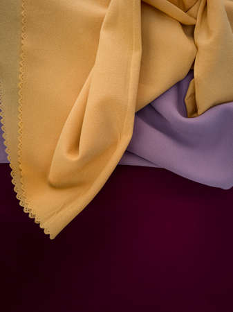 Red yellow and light brown textured abstract cloth backgroundの写真素材