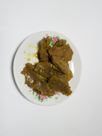 Beef rendang dish with delicious spices on a white plateの写真素材