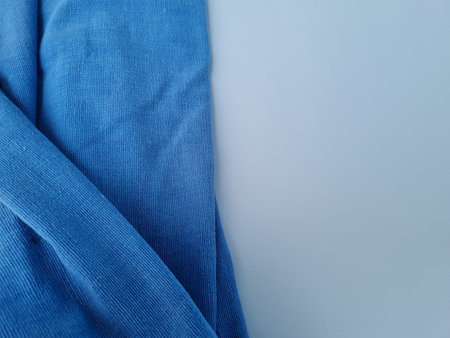 Abstract textured background of blue blanket cloth combined with whiteの写真素材