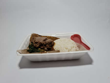 Padang rice with seasoned chicken, green chili sauce, and green cassava leaf vegetablesの写真素材