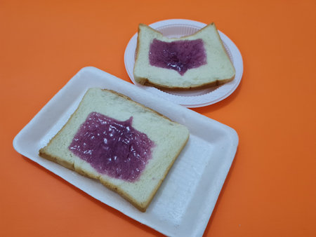 Bread made from flour and other ingredients with spread or filling with blueberry jam
